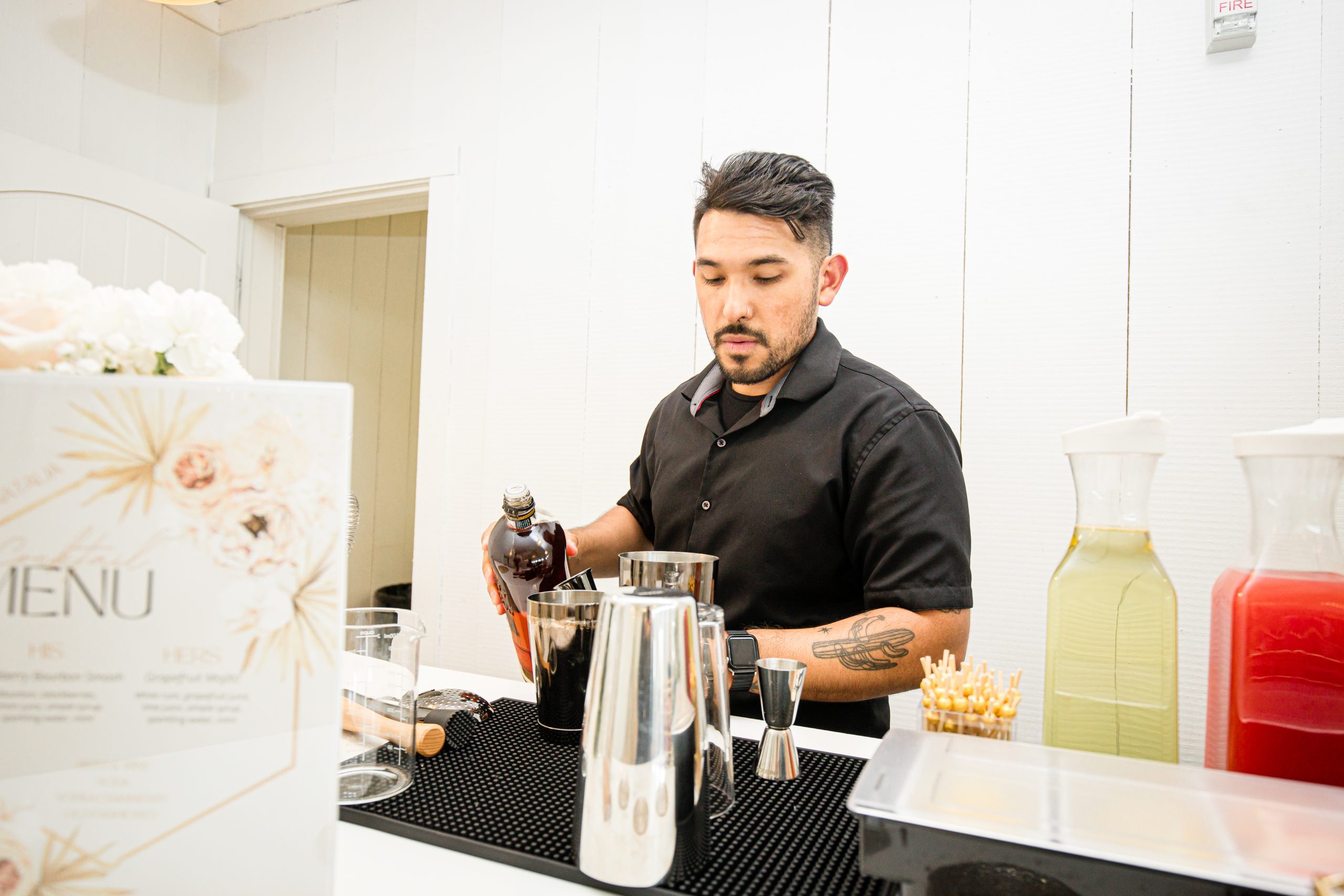 A Lucky Chandelier bartender serving guests at a venue bar, no trailer