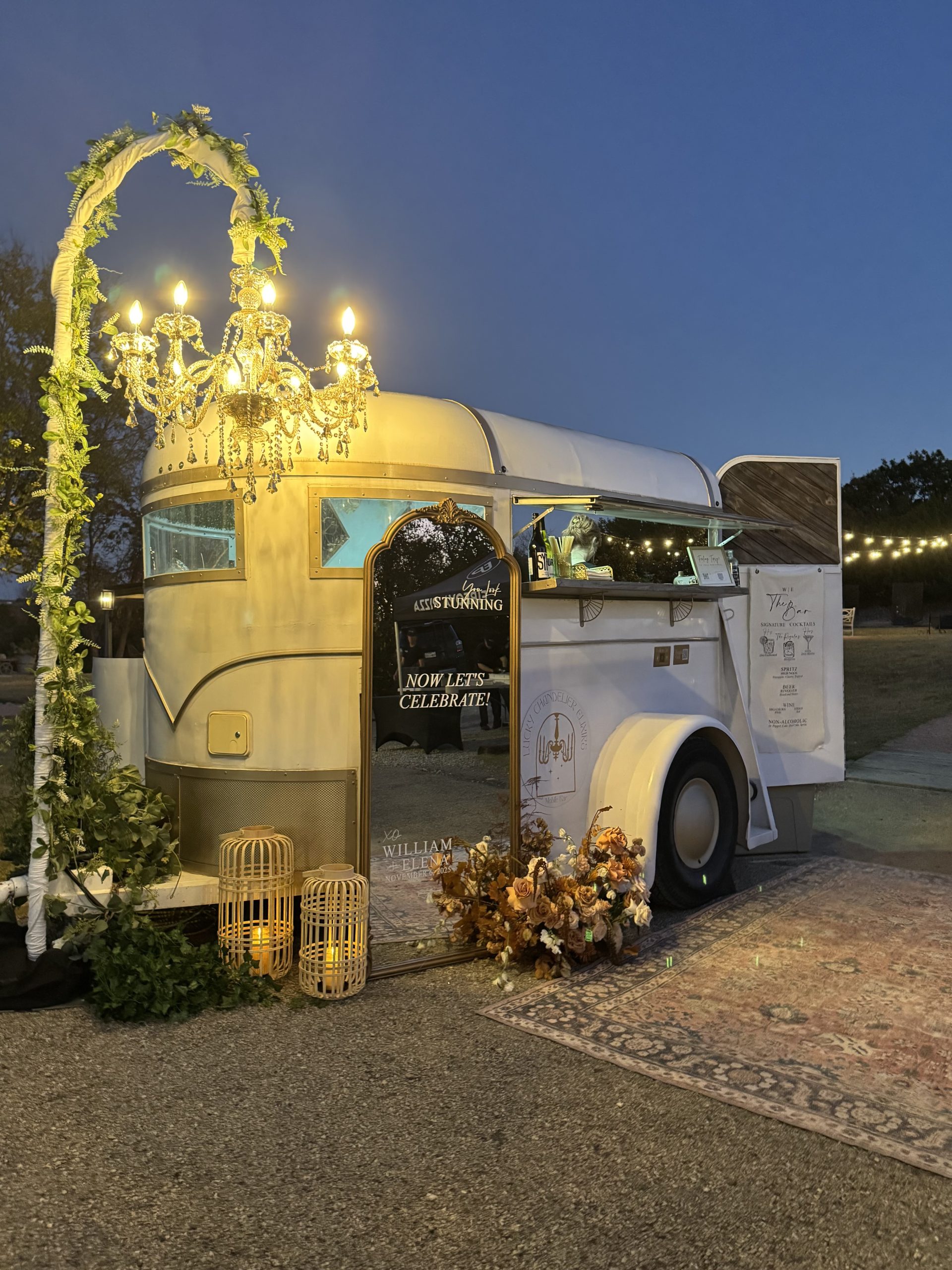 The Lucky Chandelier trailer and lit chandelier arch at dusk