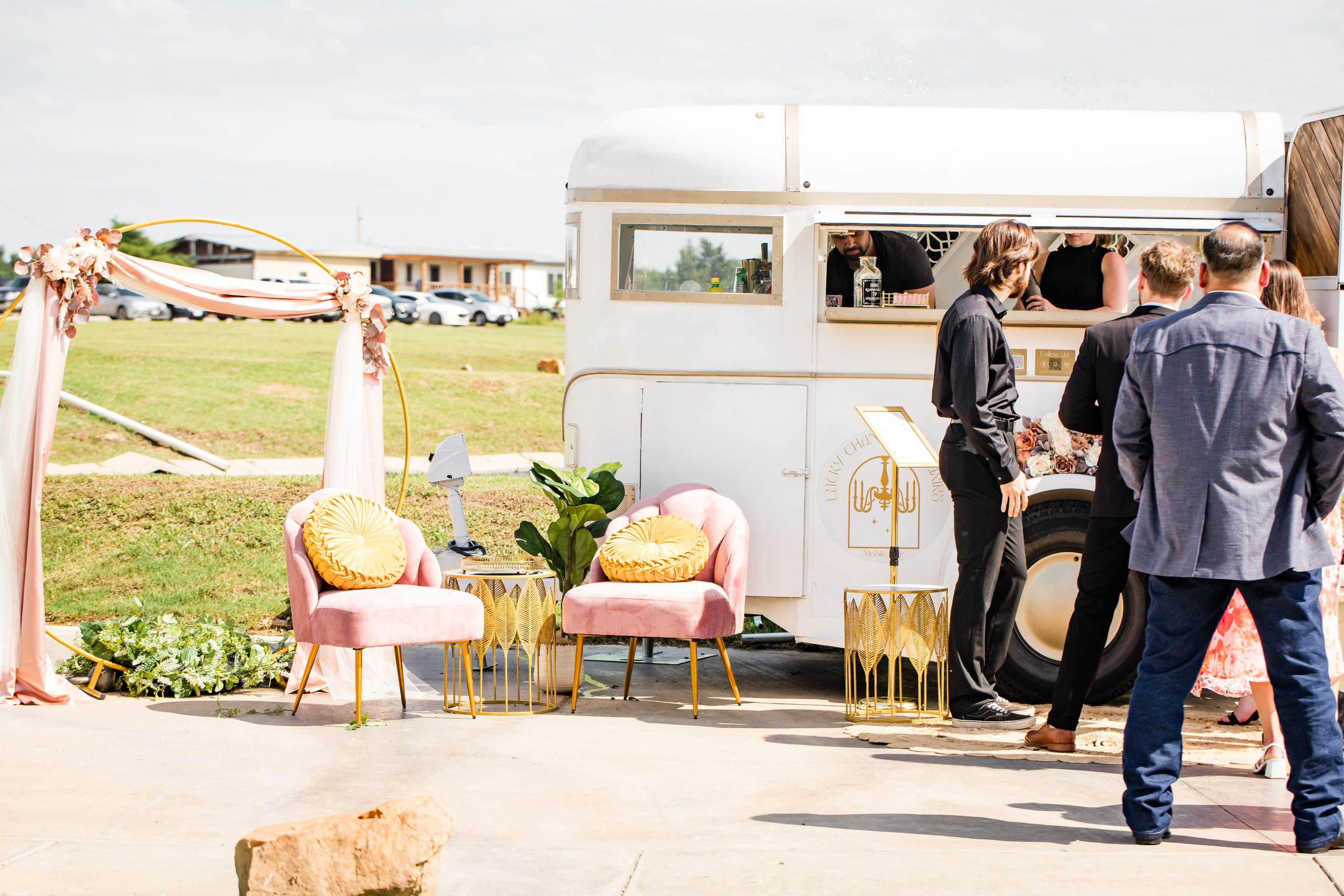 Guests gathering at the trailer window while bartenders serve drinks