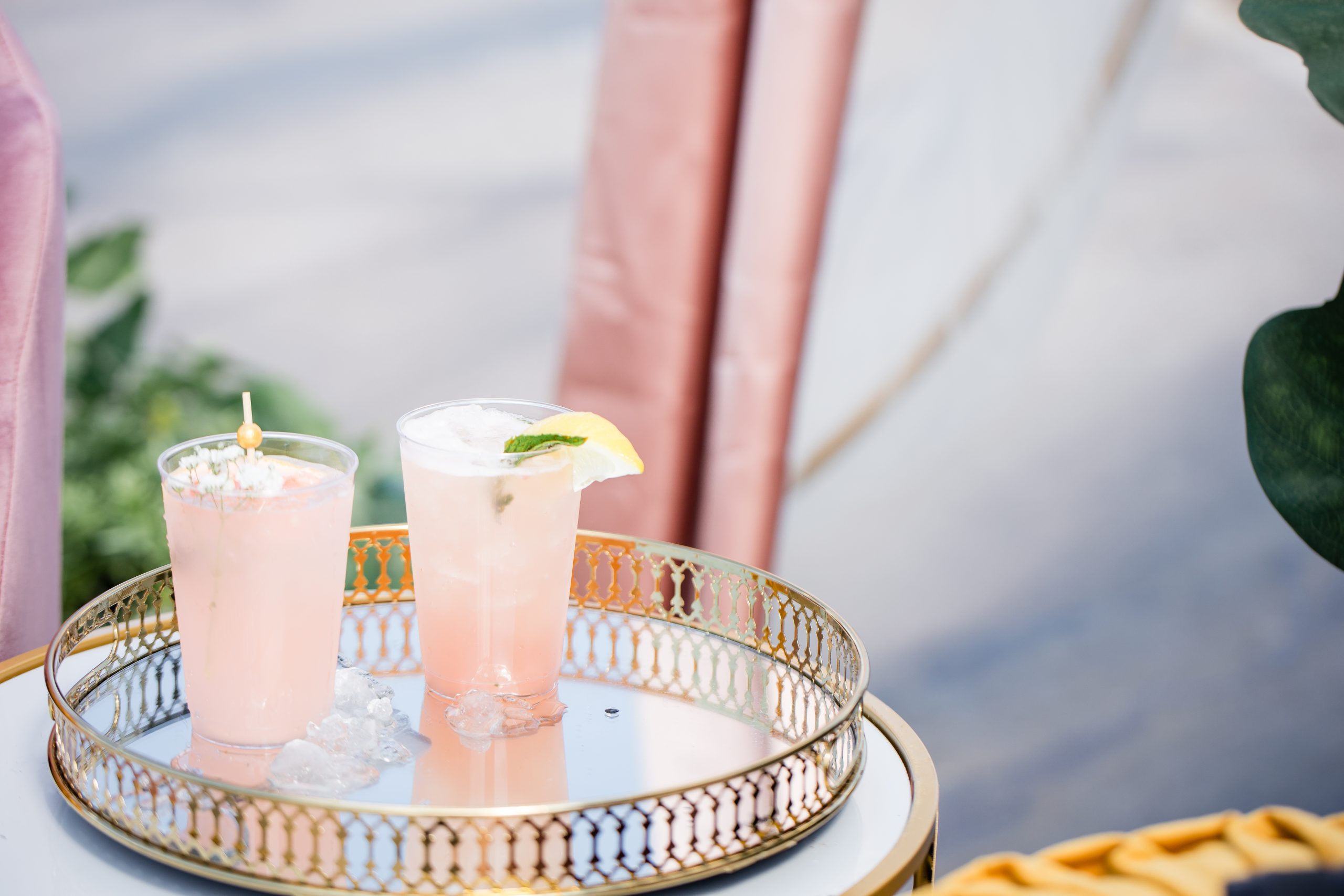 Two signature cocktails on a mirrored tray